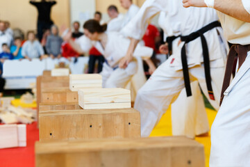 Martial artists breaks the wooden boards by hand