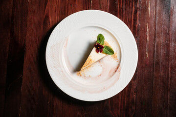 Piece of cheesecake. Sweet dessert decorated with mint.