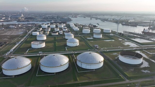 Commercial petrochemical oil gas fuel storage crude energy silos terminal at large industrial port. Huge storage of liquid aerial drone view in the port of Amsterdam, The Netherlands.