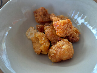 Pork skin fried on a white plate