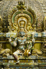 Fototapeta na wymiar Old statues on the facade of Seetha Amman kovil hindu temple