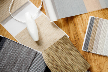 Samples of fabrics of different textures and colors in the form of a catalog for the selection of fabrics for fabric blinds. Samples of blinds day and night.