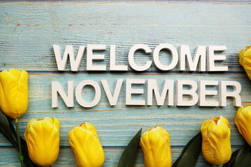 Welcome November alphabet letters with tulip flower on wooden background