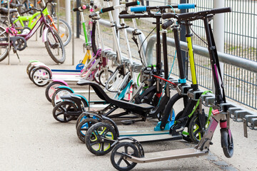 Scooters Parking at School.  Children's Scooters. Public Bicycle Lock Station for Scooters. 