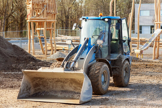 Tractor Excavator with soil pile on Constuction site of Wooden Playground