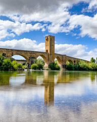 medieval bridge with reflection on the river