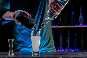 Bartender's hands serving cocktails on bar counter in a restaurant, pub. Mixed drinks. Alcoholic...