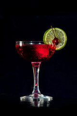 Cocktail in a glass on a bar counter in a restaurant, pub. Fresh prepared alcoholic cooler beverage at nightclub