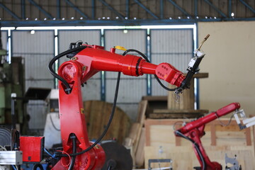 Robotics arm in the metal factory plant . it's performing routine servicing of the welding robotics units equipment.