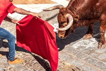 Fotobehang Man bullfighting in the streets of Arcos de la Frontera during Holy Week at the Aleluya festivities. Selective focus. © javidestock
