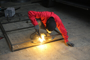 Fototapeta na wymiar Industrial Worker at the factory welding closeup