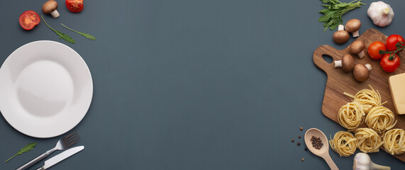 Culinary gray background. Ingredients for pasta, pasta with tomatoes, mushrooms and cheese.