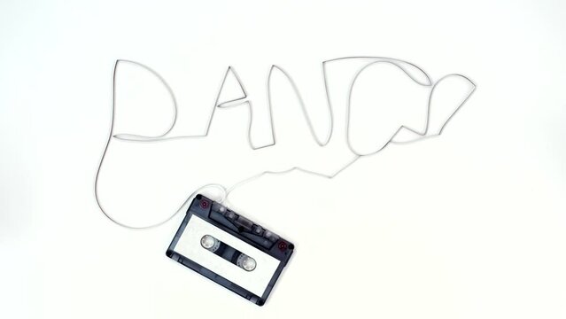 Retro cassette on a white background. Film forming the word dance. 4K UHD video.