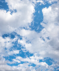 broken cloud cover and blue sky, vertical
