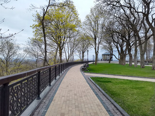 Volodymyrska Hill park road with benches and gazebo in Kyiv, Ukraine on a spring day