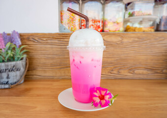 Iced pink milk favorite drink in Thailand. Sweet drink red sugar syrup with fresh milk and milk...