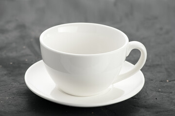 close-up shot of a white porcelain mug on a black background