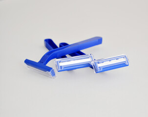 disposable blue shaving razor on light background