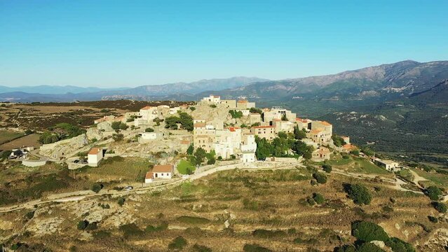 The city of Sant'Antonino in the middle of the arid and green mountains, in Europe, in France, in Corsica, by the Mediterranean Sea, in summer, on a sunny day.