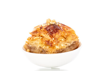 Sweet baklava classic with ceramic dishes, macro, isolated on a white background.