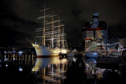 Gothenburg, Sweden. Night view of the Lilla Bommen harbor with the ship Barken Viking, the biggest sailing ship ever built in Scandinavia, and the Lilla Bommen Building.