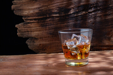 Whiskey or alcoholic beverages or bourbon with ice on the wooden floor and a black and white scene with a top view