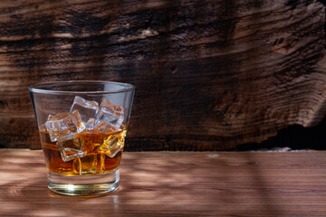 Whiskey or alcoholic beverages or bourbon with ice on the wooden floor and a black and white scene with a top view