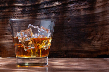 Whiskey or alcoholic beverages or bourbon with ice on the wooden floor and a black and white scene with a top view
