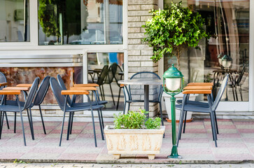 Fototapeta na wymiar Chairs in the garden restaurant in Leptokarya, Greece.
