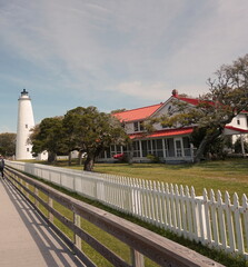 White Ocracoke Lighthouse and Red Roofed House on Sunndy Day