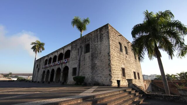 View from the stairs to the Alcazar de Colon at sunrise. Historical building on the Plaza de la Hispanidad or Spain in the Colonial City of Santo Domingo, Dominican Republic