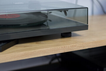 Closed vinyl player on wooden table