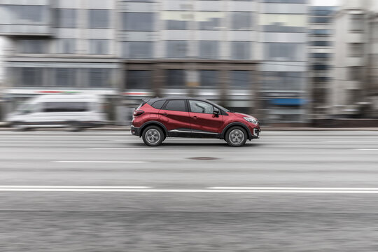 car Renault Captur First generation crossover driving along the street in city with blurred background