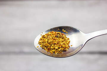Pour dried natural organic herbs into a spoon. Herbal medicine.