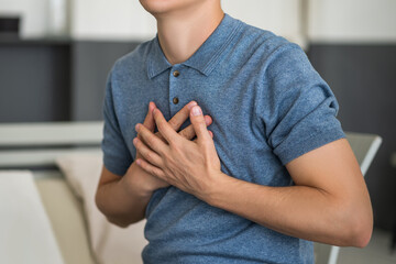 Heart attack, man with chest pain suffering at home - obrazy, fototapety, plakaty