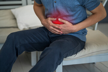 Stomach ache, man with abdominal pain suffering at home - obrazy, fototapety, plakaty