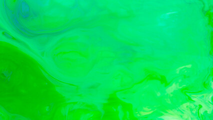 Fototapeta na wymiar Fluid art background in green color. Green-turquoise stains on liquid. Background for an eco-friendly concept