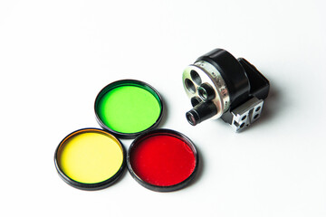 Multi-colored filters and viewfinder on a white background.