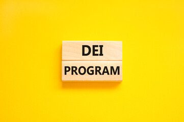 DEI diversity equity inclusion program symbol. Blocks with words DEI program on beautiful yellow background. Business DEI diversity equity inclusion program concept. Copy space.