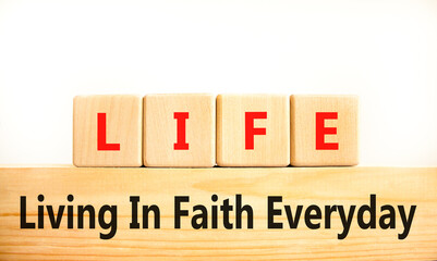 LIFE living in faith everyday symbol. Concept words LIFE living in faith everyday on wooden blocks on a beautiful white background. Business LIFE living in faith everyday concept. Copy space.
