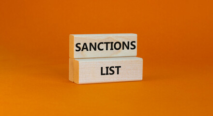 Sanctions list symbol. Wooden blocks with concept words Sanctions list on beautiful orange...