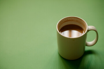 cup of coffee on green background