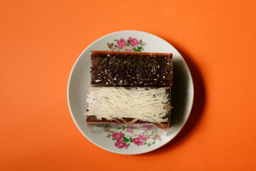 chocolate and cheese brownie wrapped with transparent plastic on plate