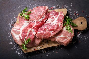 fresh pork meat with rosemary and spices, top view
