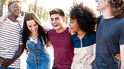 Multiracial smiling friends having fun walking on city street - Happy young people laughing and...