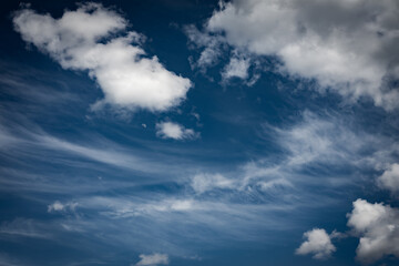 Fototapeta na wymiar Moon hiding in the clouds with blue sky