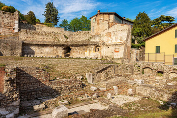 Fototapeta na wymiar Old Ruins of the Roman Theatre or Amphitheater in Brescia downtown near the Capitolium Roman Temple (Tempio Capitolino), 1th century AC, UNESCO world heritage site, Lombardy, Italy, Europe.
