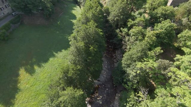 Rivi&egrave;re qui serpente dans une for&ecirc;t aux arbres verts au printemps dans la nature sauvage des C&eacute;vennes en France.