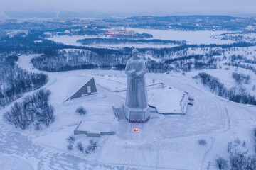 Aerial view of Monument to the Defenders of the Arctic (the main symbol of the town) on short winter day. Murmansk, Russia.