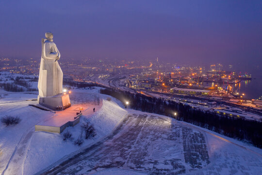 Aerial view of Monument to the Defenders of the Arctic (the main symbol of the town) on winter blue hour. Murmansk, Russia.